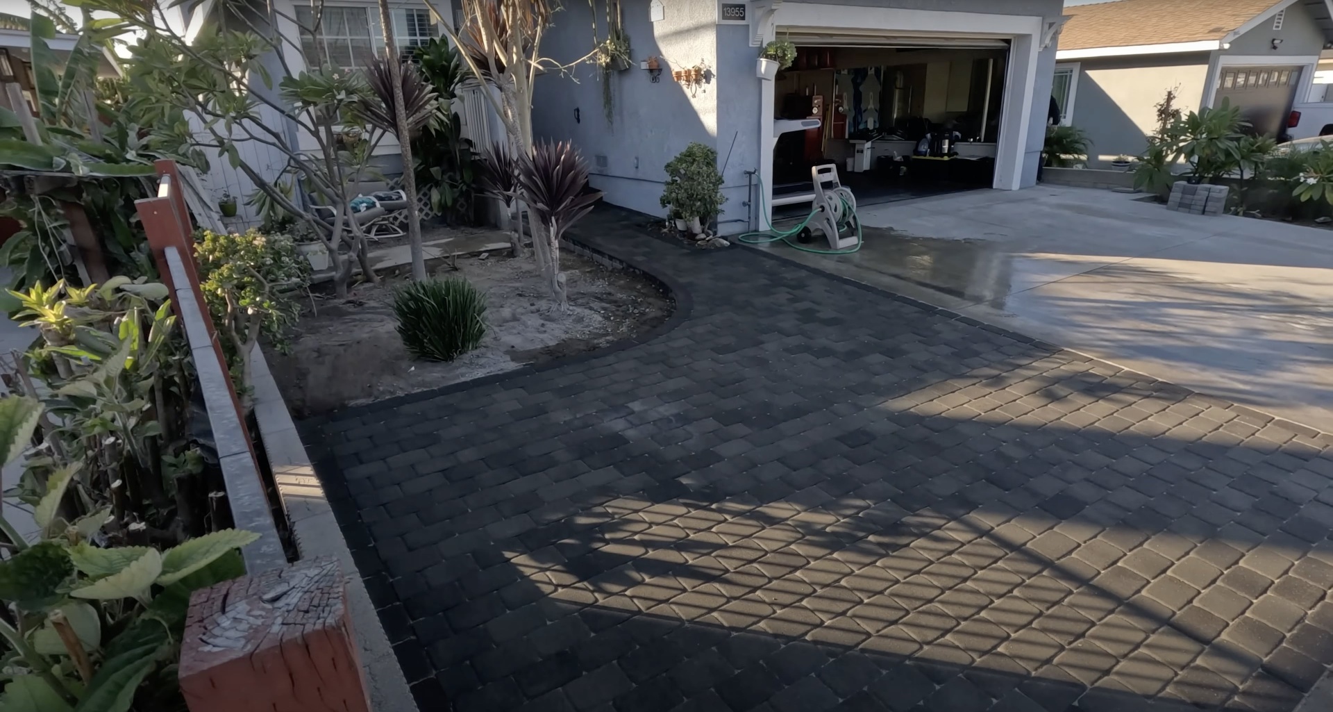 Professional garage floor concrete installation with decorative elements Polished concrete garage floor with decorative paver accent strip